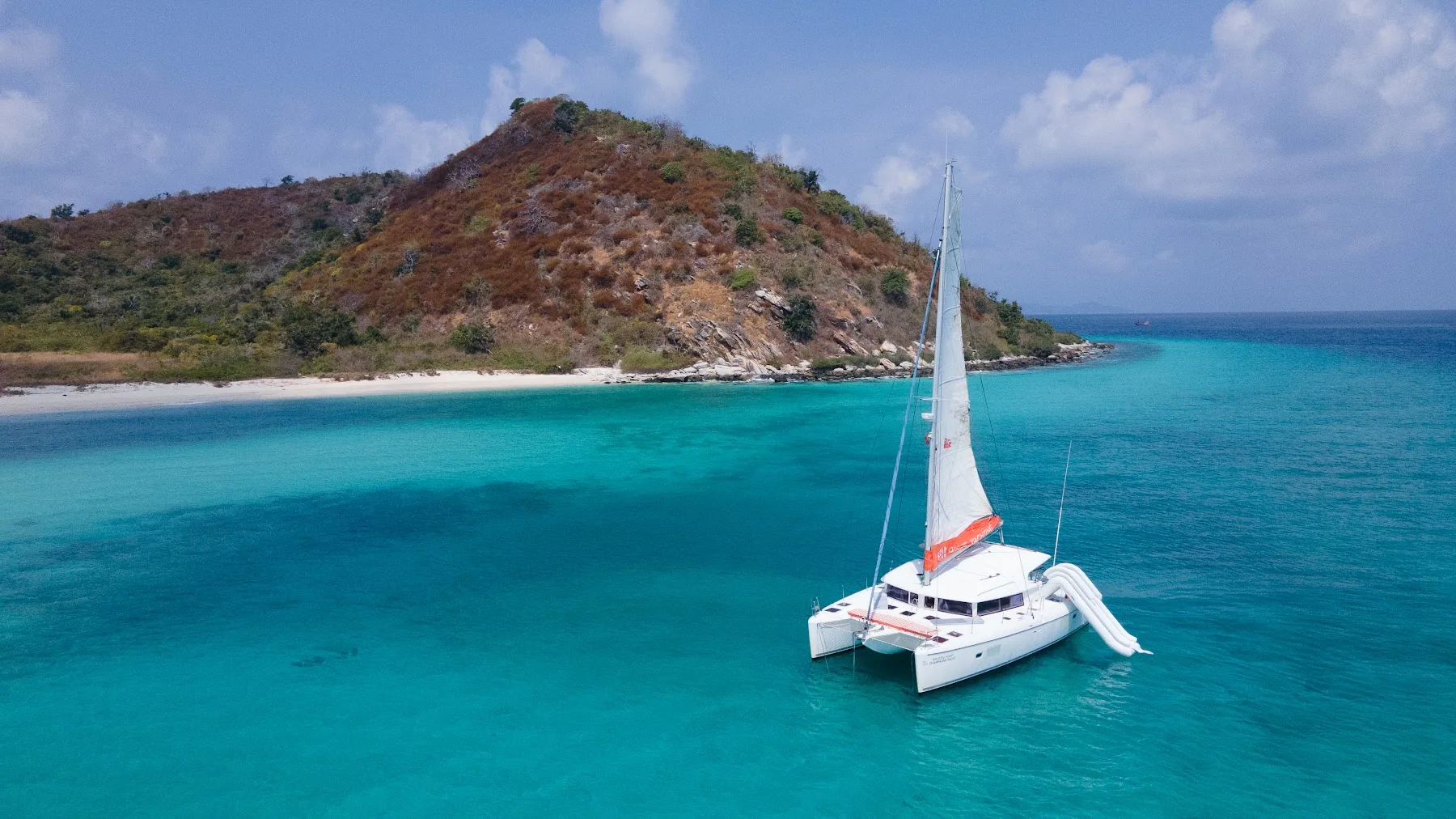 Champagne sailing catamaran in coastal waters